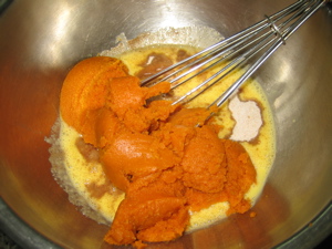 Eggs, sugar, and pumpkin mixed